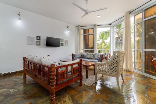 a living room with a bed and a table and chairs at Lafayette One Bedroom Apartment, with Beach Access, Malindi in Malindi