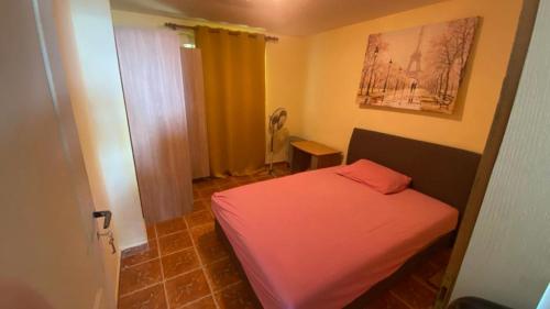 a small bedroom with a red bed in a room at Extra lokacija!!!!! in Sutomore