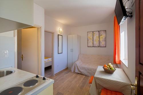 a small room with a bed and a sink at Royal Garden Apartments & Gastronomy in Budva