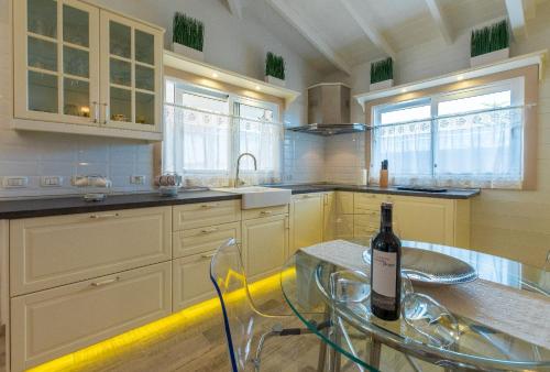 a kitchen with a glass table and a bottle of wine at Villa Karla con Piscina: Tranquilidad y Naturaleza in Adeje