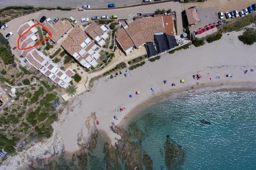 an aerial view of a beach with people on the sand at Hôtel et Résidence Ta Kladia - Omigna in Cargèse