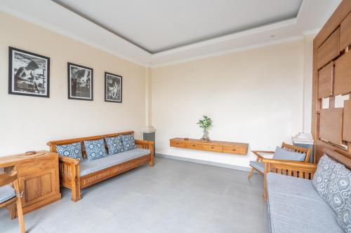 a living room with a couch and a table at Oka Suite Sebatu Ubud in Tampaksiring