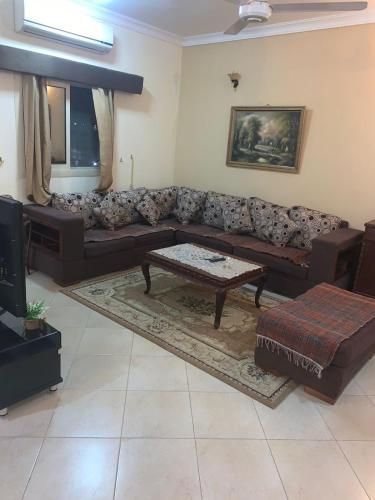 a living room with a couch and a coffee table at شقة عائلية راااقية ورائعة وسط الغردقة in Hurghada