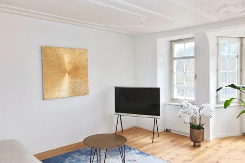 a living room with a flat screen tv on a wall at The R Apartment Cholfirst in Schaffhausen