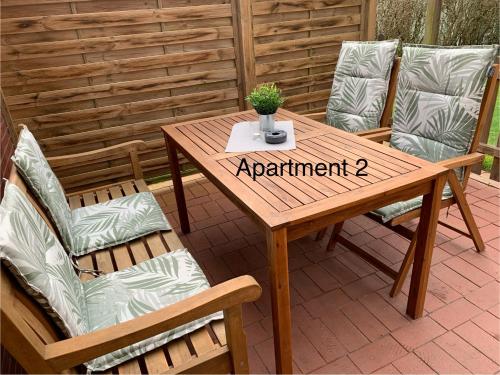 een houten tafel en stoelen op een patio bij Eschen´s Blick in Aurich