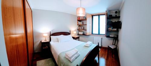 a bedroom with a bed with two towels on it at Casa da Senra in Vila do Conde