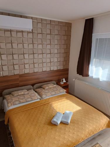 a bedroom with two beds with towels on them at Boglárka Vendégház in Mosonmagyaróvár