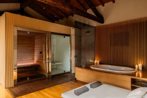 a large bathroom with a tub and a shower at Grand Hotel Tremezzo in Tremezzo