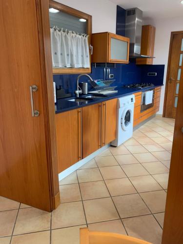a kitchen with a sink and a washing machine at Chic apartment beach in Mataró