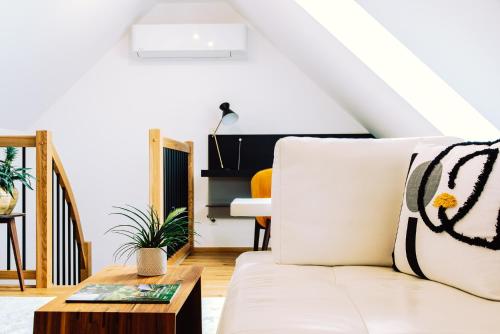 a living room with a white couch and a coffee table at Klöchberg Relaxing & Living in Klöch