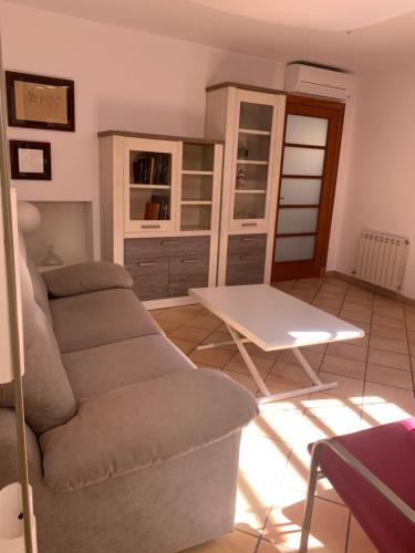 a living room with a couch and a table at Chic apartment beach in Mataró