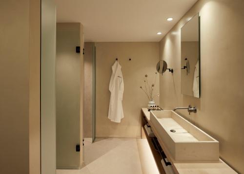 La salle de bains est pourvue d'un lavabo et d'un miroir. dans l'établissement PAROCKS Luxury Hotel & Spa, à Ambelas