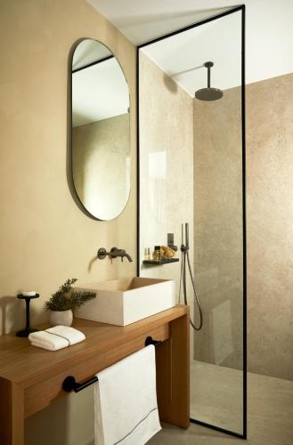 a bathroom with a sink and a mirror at PAROCKS Luxury Hotel & Spa in Ambelas