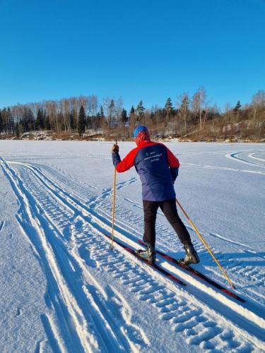 a man is cross country skiing on the snow at Lõõdla Holiday House in Lümatu