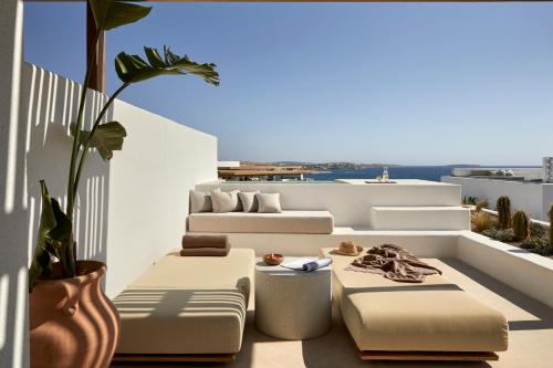 a balcony with two couches and a table at PAROCKS Luxury Hotel & Spa in Ambelas