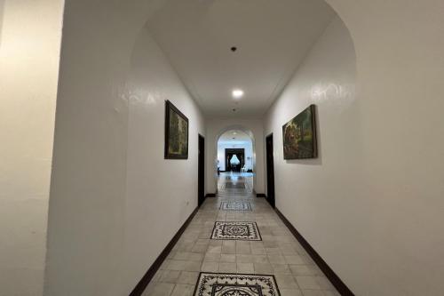 a hallway with white walls and a tile floor at NSCC Casa De Vigan in Vigan
