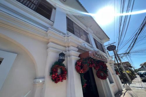 a building with christmas wreaths on the side of it at NSCC Casa De Vigan in Vigan