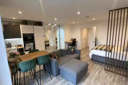 a living room with a couch and a table and a bed at London Luxe: Stylish Studio in London