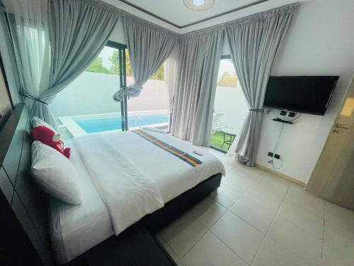 a bedroom with a bed and a large window at Les merveilles d’assinie in Assinie