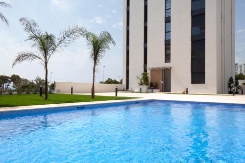 a swimming pool in front of a building at Horizonte Line in Villajoyosa