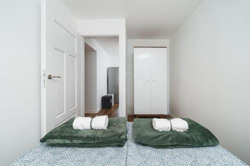 a bedroom with two beds with green sheets at Close to everywhere, cosy place in Krakow