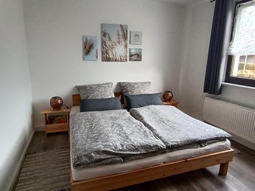 a bed in a bedroom with two pillows at Ferienwohnung Papperitz in Heiligen