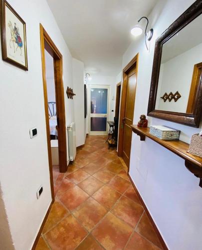 a hallway with a mirror and a tile floor at SOLEMARE in Palau
