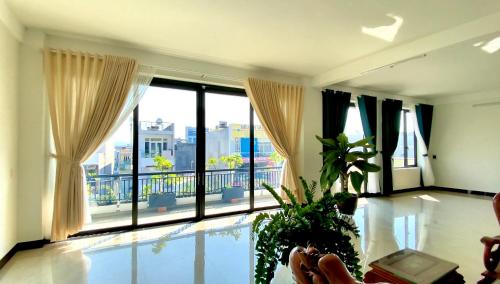a living room with a pool and a large window at Friendly Homestay in Kon Tum