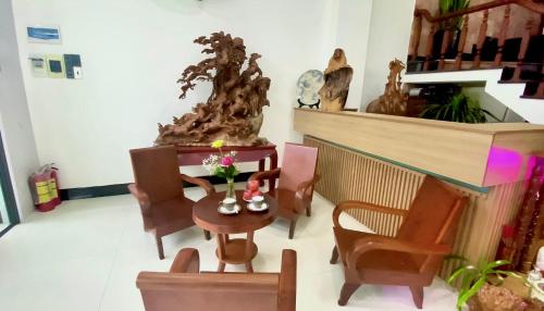 a living room with a table and chairs and a fireplace at Friendly Homestay in Kon Tum