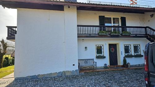 ein weißes Haus mit Balkon darüber in der Unterkunft Ferienwohnung Rebensburg in Point
