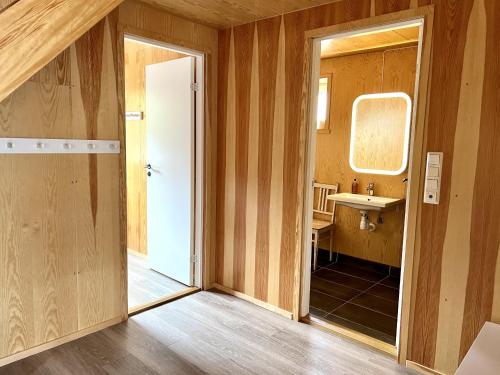 a bathroom with a sink and a mirror at Fjordview Ryten 2 Retreat in Sund