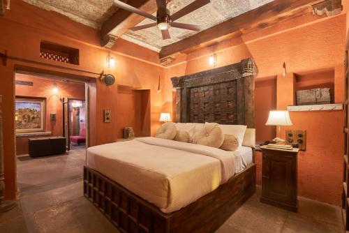 a bedroom with a large bed in a room at Kaladwas Lal Haveli - A Heritage Boutique Hotel in Udaipur