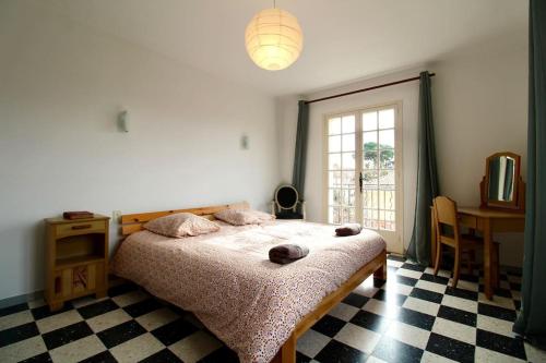 a bedroom with a bed and a table and a window at Luberon Large House 4 bedrooms in La Tour-dʼAigues