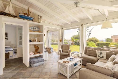 a living room with a couch and a table at Villa Le Pigne in Favignana