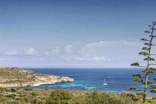 a view of the ocean with boats in the water at Villa Le Pigne in Favignana