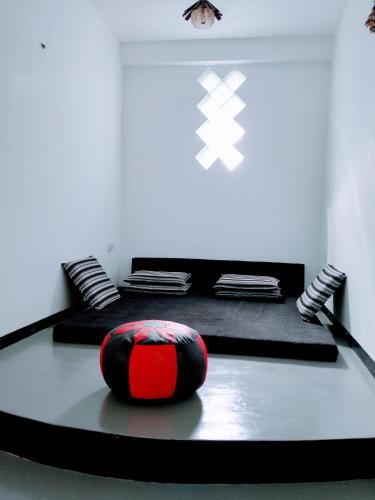a room with two meditation mats and a red ball at Area 51 Apartment in Mirissa