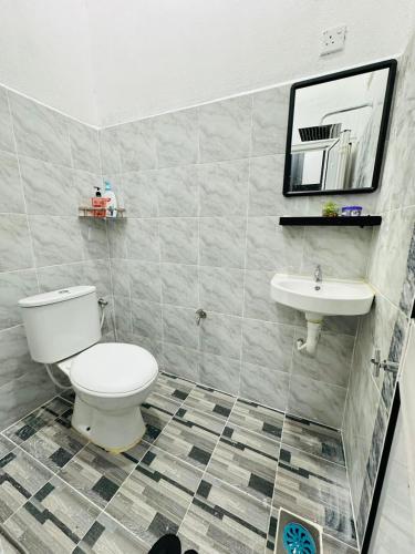 a bathroom with a toilet and a sink at Abe Pu Homestay Machang 1 in Machang