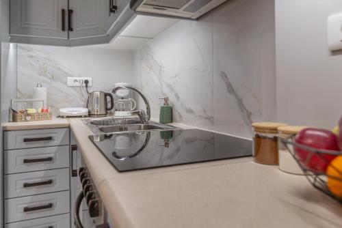 a kitchen with a sink and a counter top at Liros House in Nafpaktos