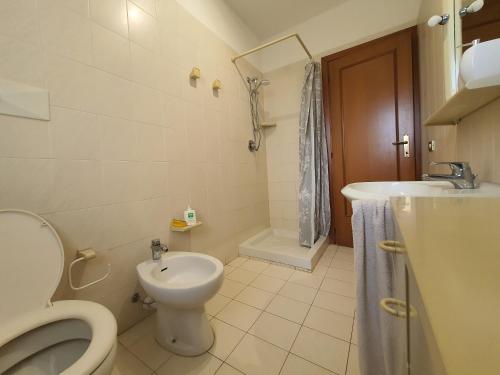 a bathroom with a toilet and a sink at Casa Mare Atene in Follonica