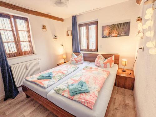a bedroom with two beds and two windows at Urlaubsmagie - Urlaubstraum mit (Whirl-)Pool & Sauna - UT in Sebnitz