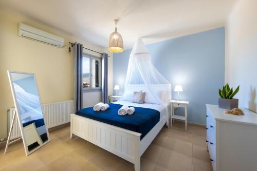 a bedroom with a bed with towels on it at Princess Sofia Luxury Villa (with private pool) in Kampos Paros