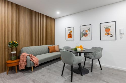 a living room with a couch and a table at Boavista Executive Studios in Porto