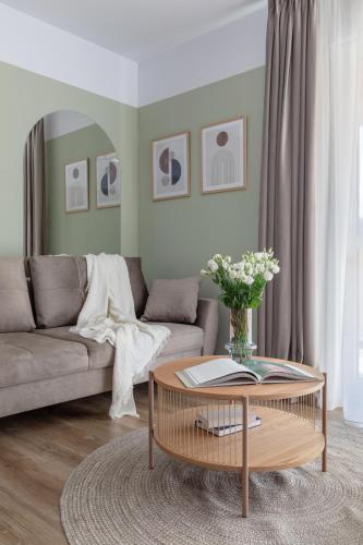 a living room with a couch and a coffee table at Dream Garden Apartment - Free Parking - Welness Jacuzzi SPA in Sinaia