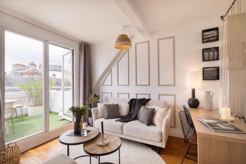 un salon avec un canapé et une table dans l'établissement Amalfi - Studio et terrace à Auteuil, à Paris