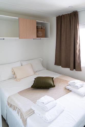 a bedroom with two beds with towels on them at Club del Sole Romagna Family Resort in Riccione