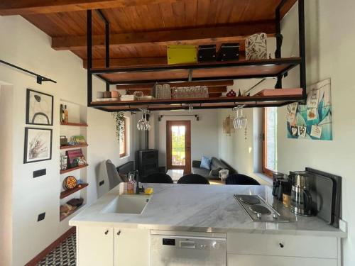 a kitchen with a counter top and a living room at Doğa da bir ev… in Ürgüp