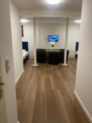 an office with a desk and a tv in a room at Hanseat Apartments in Hamburg