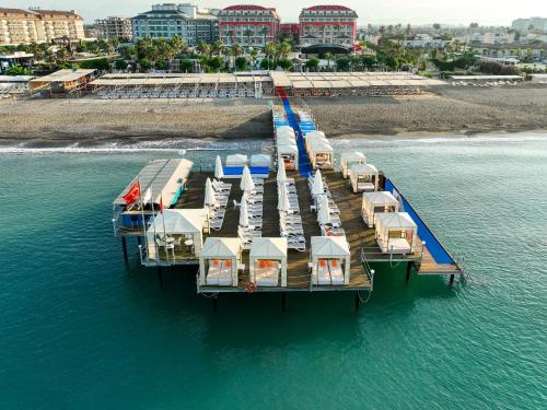 an aerial view of a dock with boats in the water at Orange County Belek in Belek