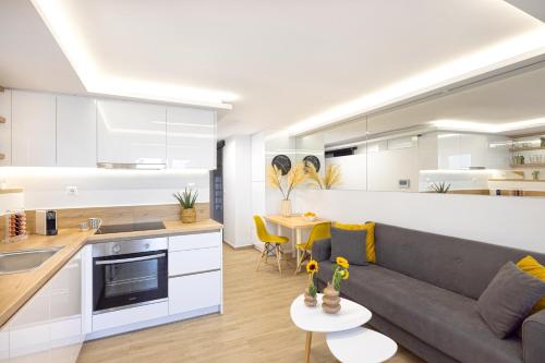 a kitchen and living room with a couch and a table at Live Your Myth in Thissio in Athens