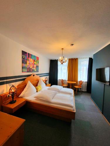 a bedroom with a large bed and a table at Hotel Atlanta in Munich
